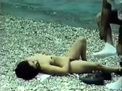 On the beach, a traditional brunette with little mounds blowing cock
